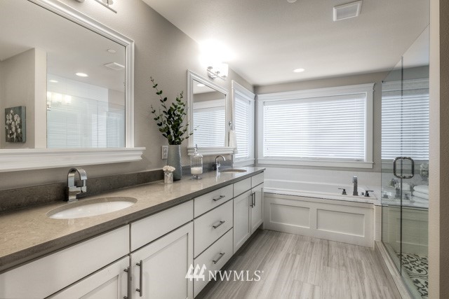23226 7th Drive Southeast Bothell, WA 98021 - Photo 14 of 24 a bathroom with a double vanity sink a mirror and a bathtub