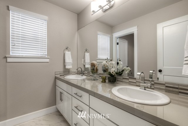 23226 7th Drive Southeast Bothell, WA 98021 - Photo 20 of 24 a bathroom with double vanity sinks and a mirror