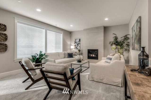 23226 7th Drive Southeast Bothell, WA 98021 - Photo 7 of 24 a living room with furniture a fireplace and a flat screen tv