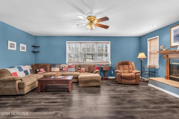 a bedroom with furniture and a large window