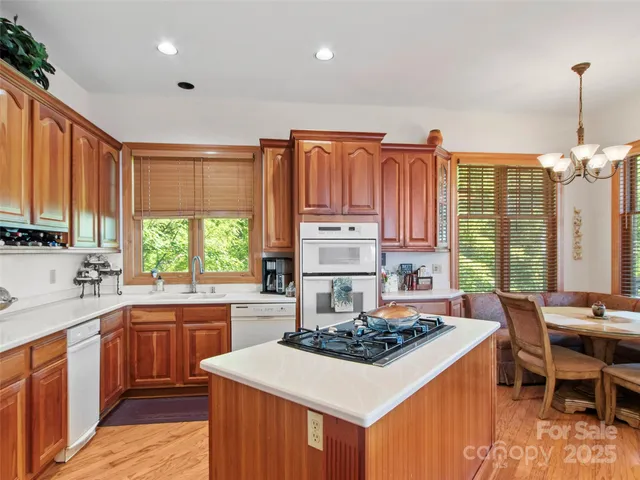 a kitchen with a stove a sink dishwasher and a refrigerator