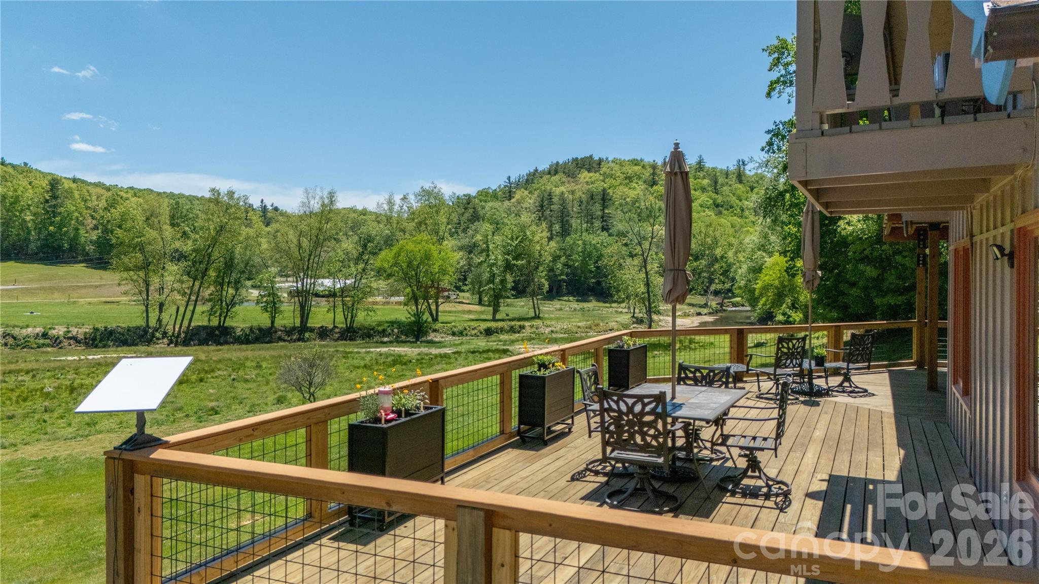 93 Franklin Crest Road Spruce Pine, NC 28777 - Photo 9 of 47 a view of a balcony with two chairs and a table