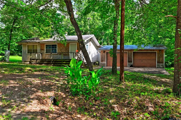 a view of a barn in the middle of a yard