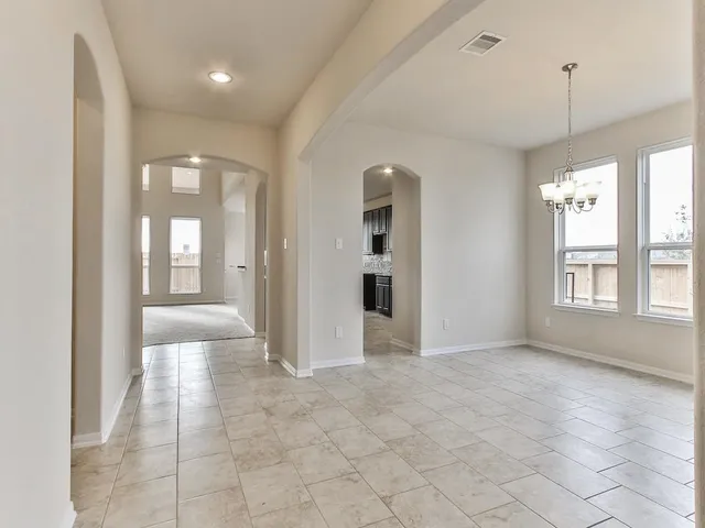 a view of an empty room with glass door