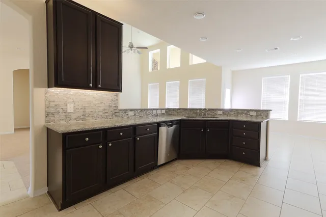 a spacious bathroom with a granite countertop sink and a mirror