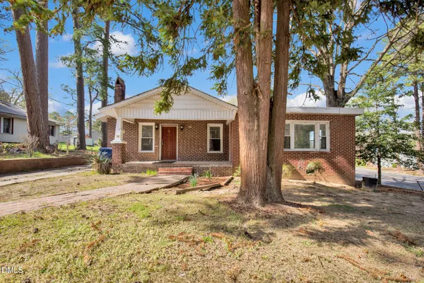 a front view of a house with garden and patio