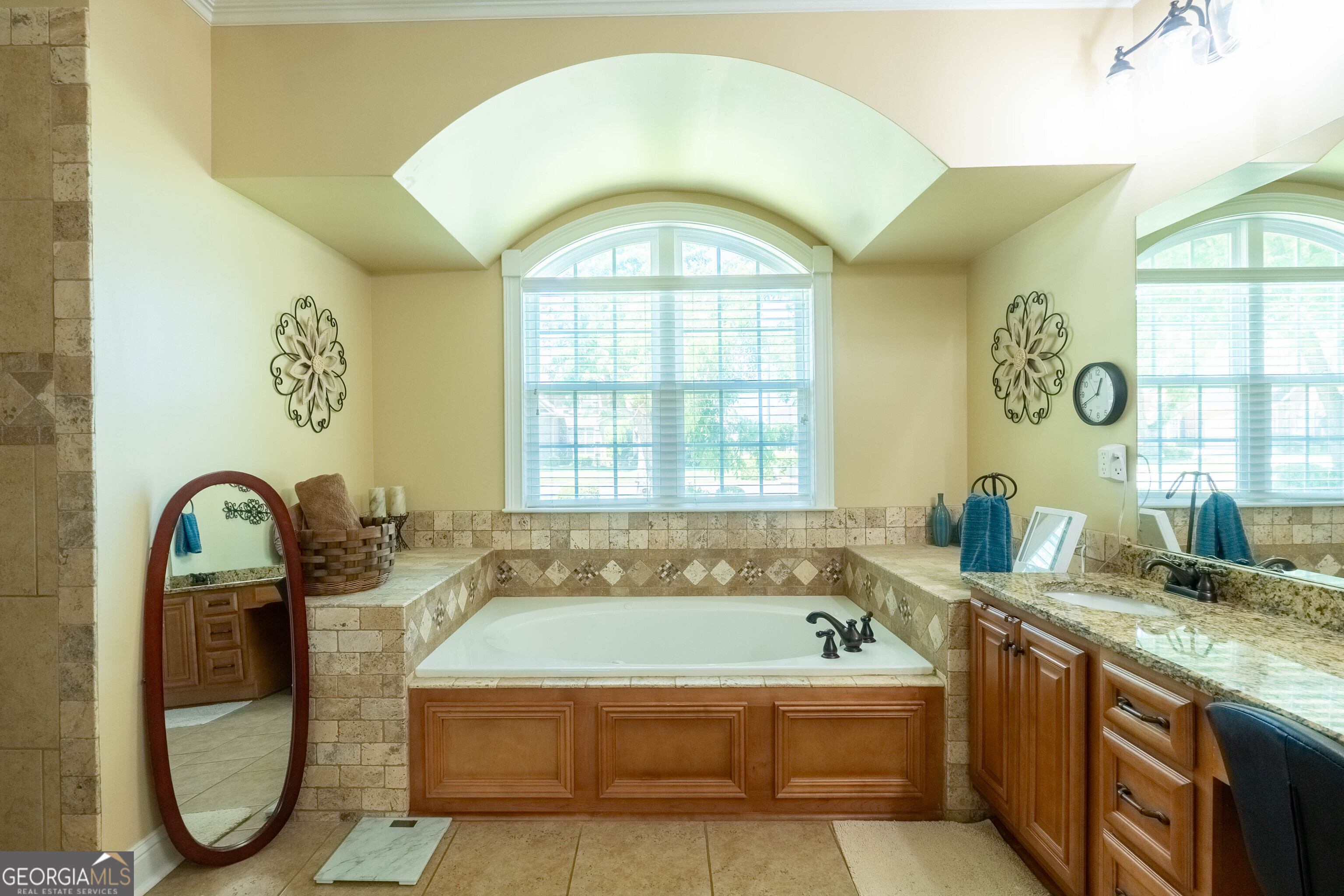 501 Old Bridge Road Warner Robins, GA 31088 - Photo 44 of 54 a spacious bathroom with a granite countertop tub a window and a sink