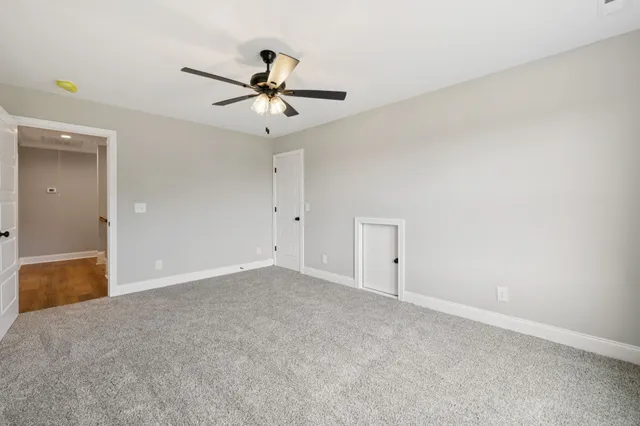 a view of a livingroom with a ceiling fan and window