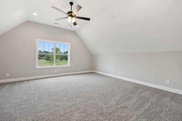 a bathroom with a granite countertop sink a toilet and a mirror