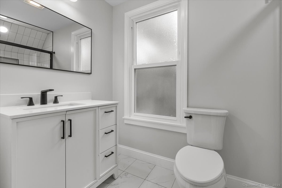 36 Maple Street, Unit 3 New Haven, CT 06511 - Photo 17 of 20 a bathroom with a toilet a sink and a mirror