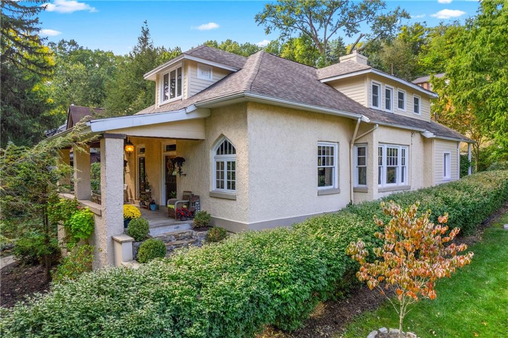 a front view of a house with yard and green space