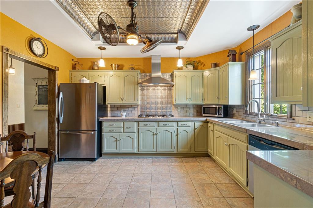 664 Hamilton Road Pittsburgh, PA 15205 - Photo 13 of 43 a kitchen with stainless steel appliances granite countertop a refrigerator and a sink