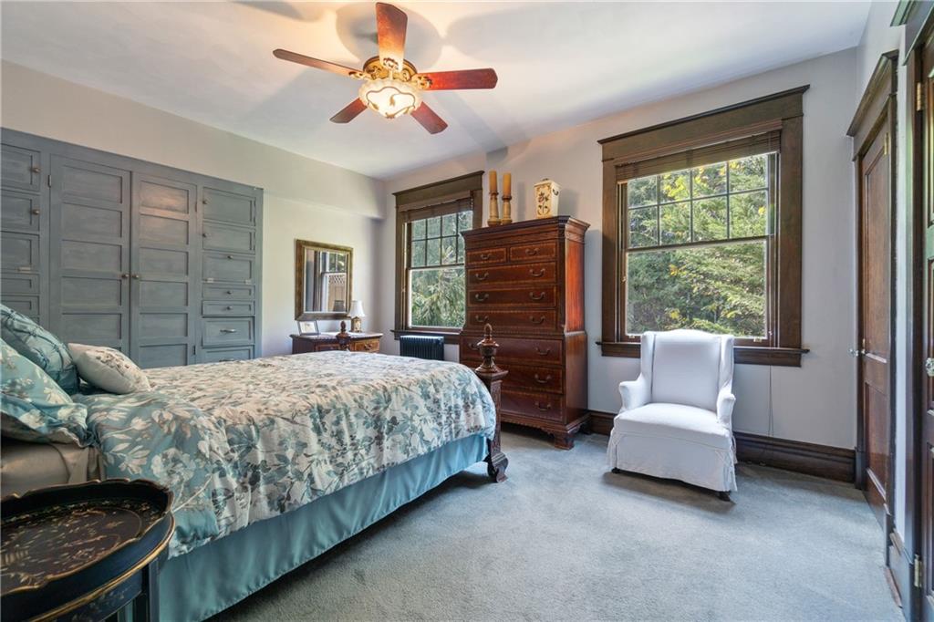 664 Hamilton Road Pittsburgh, PA 15205 - Photo 17 of 43 a bedroom with a large bed and a chandelier