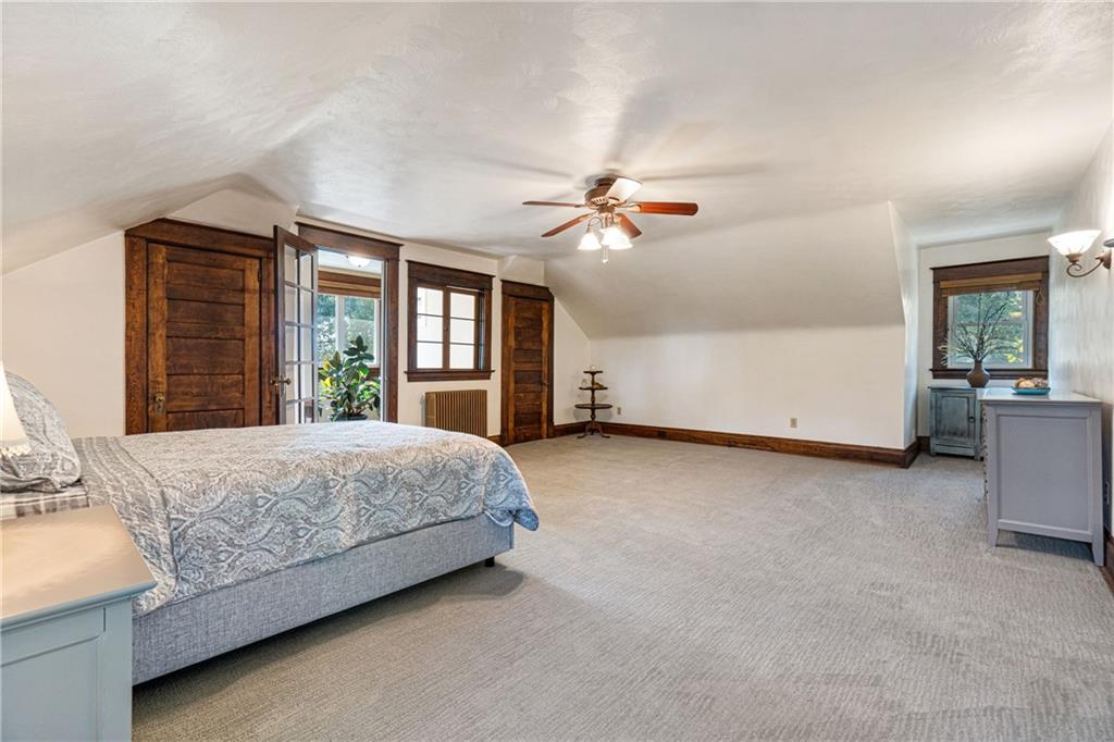 664 Hamilton Road Pittsburgh, PA 15205 - Photo 21 of 43 a spacious bedroom with a large bed and a chandelier