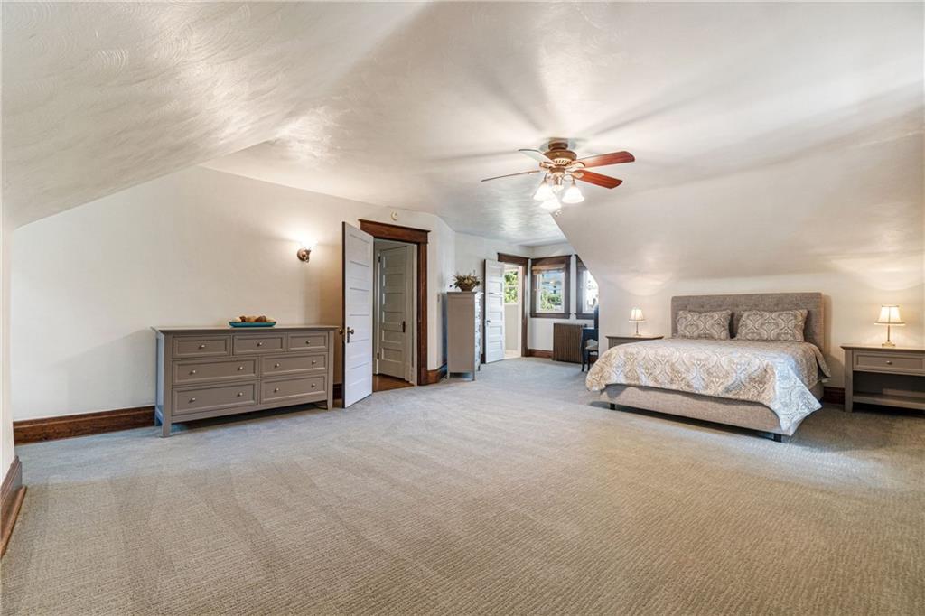 664 Hamilton Road Pittsburgh, PA 15205 - Photo 24 of 43 a spacious bedroom with a bed a chandelier and a chandelier