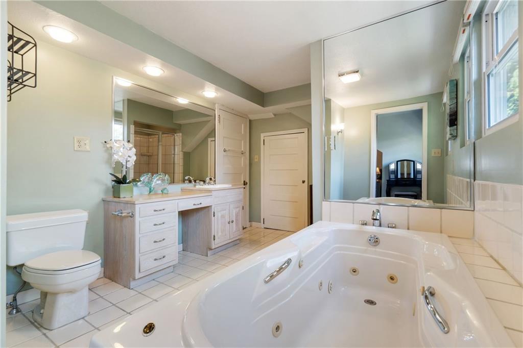 664 Hamilton Road Pittsburgh, PA 15205 - Photo 25 of 43 a spacious bathroom with a toilet sink and mirror