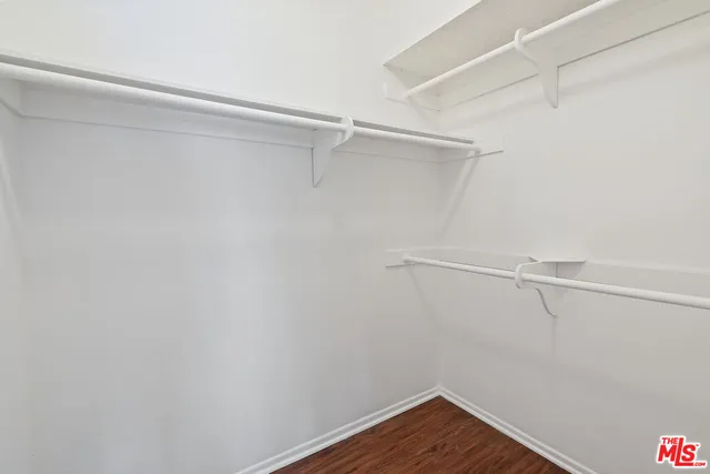 a bathroom with a granite countertop sink a toilet and a mirror