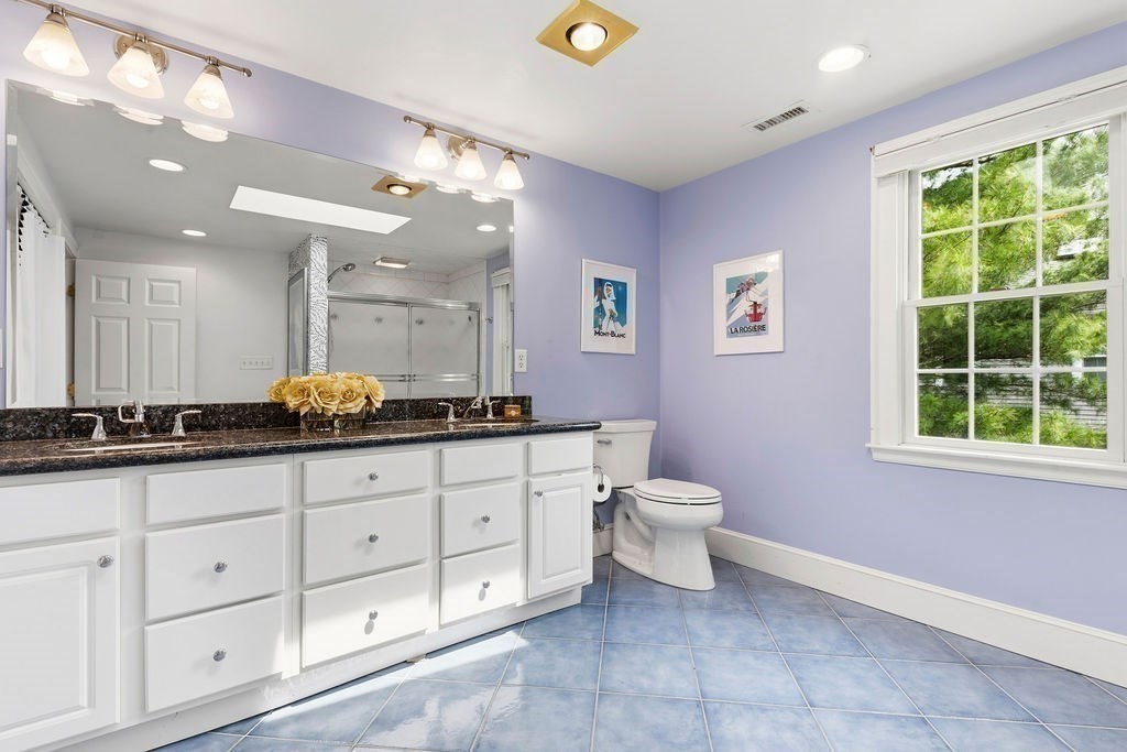 57 Douglas Road Needham, MA 02492 - Photo 19 of 22 a bathroom with a granite countertop double vanity sink a mirror a window and a bathtub