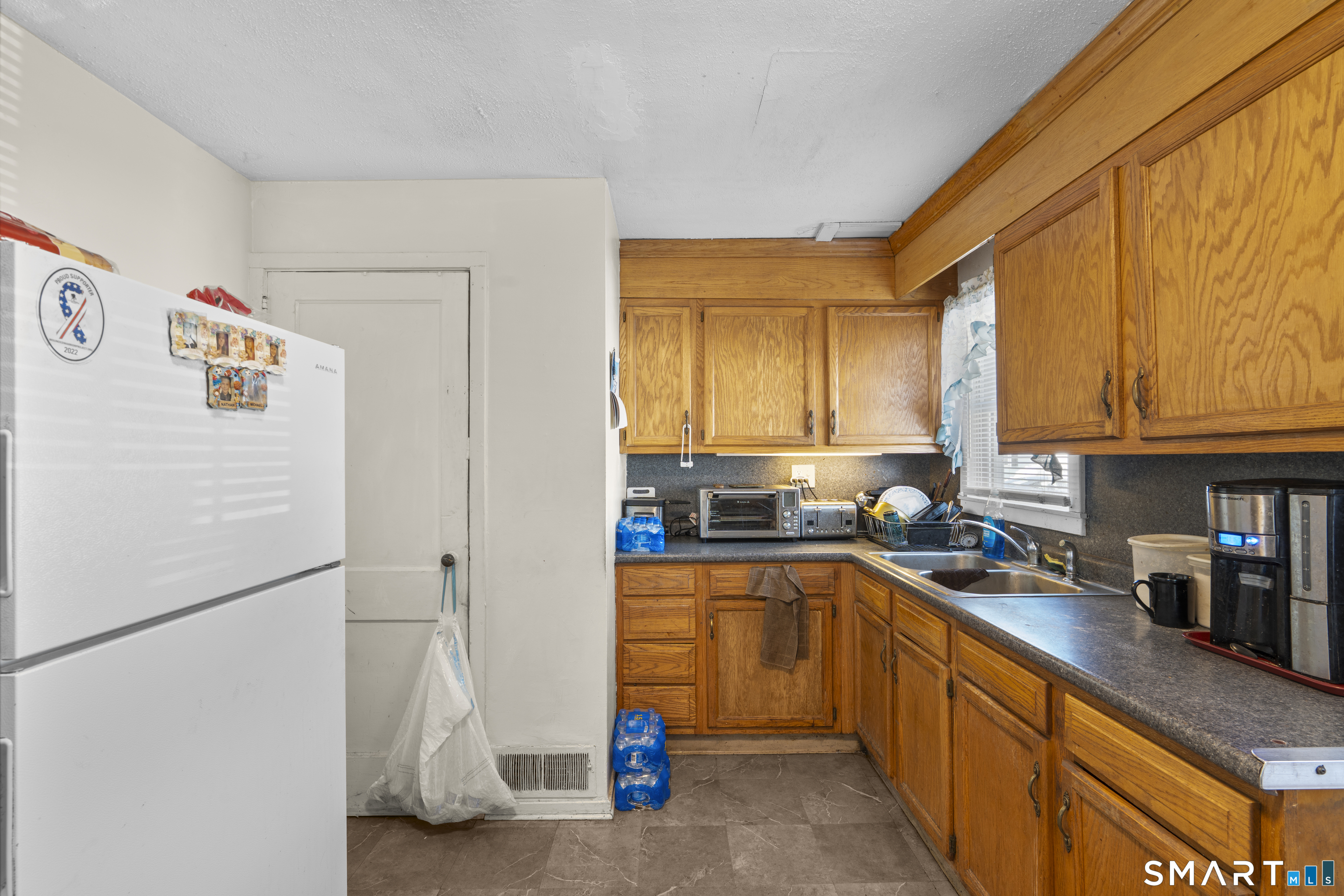 22 Tyler Circle Manchester, CT 06040 - Photo 8 of 27 a kitchen with stainless steel appliances granite countertop a sink a stove and a refrigerator