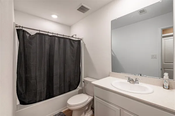 a white toilet sitting next to a bathroom sink