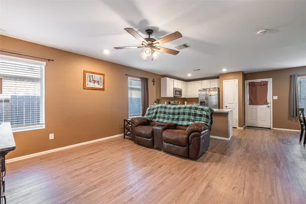 a living room with furniture and a wooden floor