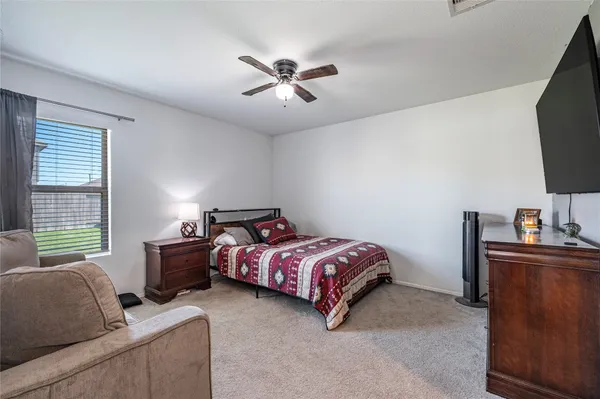a bed room with a bed and a television