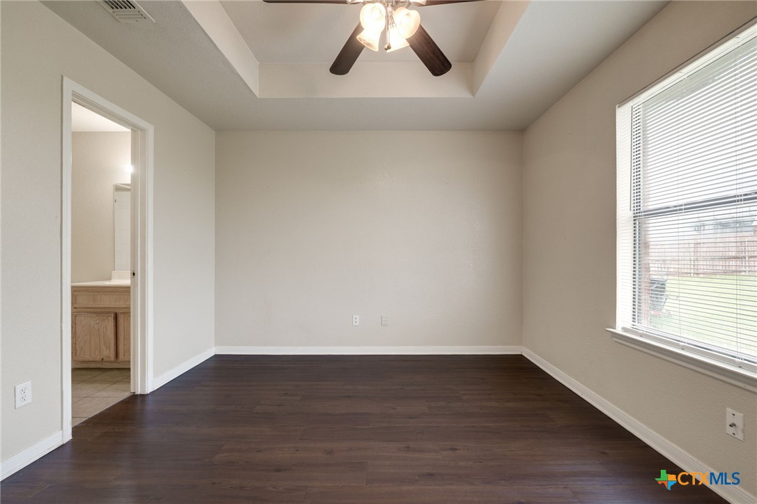 3606 Dustin Court, Unit B Killeen, TX 76549 - Photo 11 of 16 an empty room with wooden floor and windows