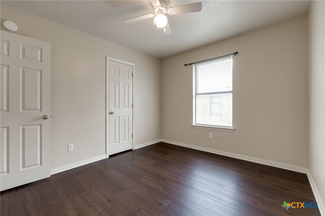 3606 Dustin Court, Unit B Killeen, TX 76549 - Photo 13 of 16 a view of an empty room with wooden floor and a window
