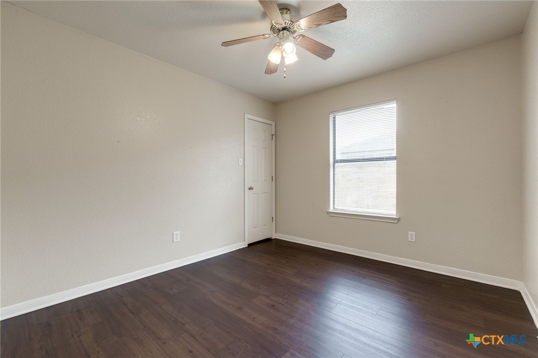 3606 Dustin Court, Unit B Killeen, TX 76549 - Photo 15 of 16 wooden floor in an empty room with a window
