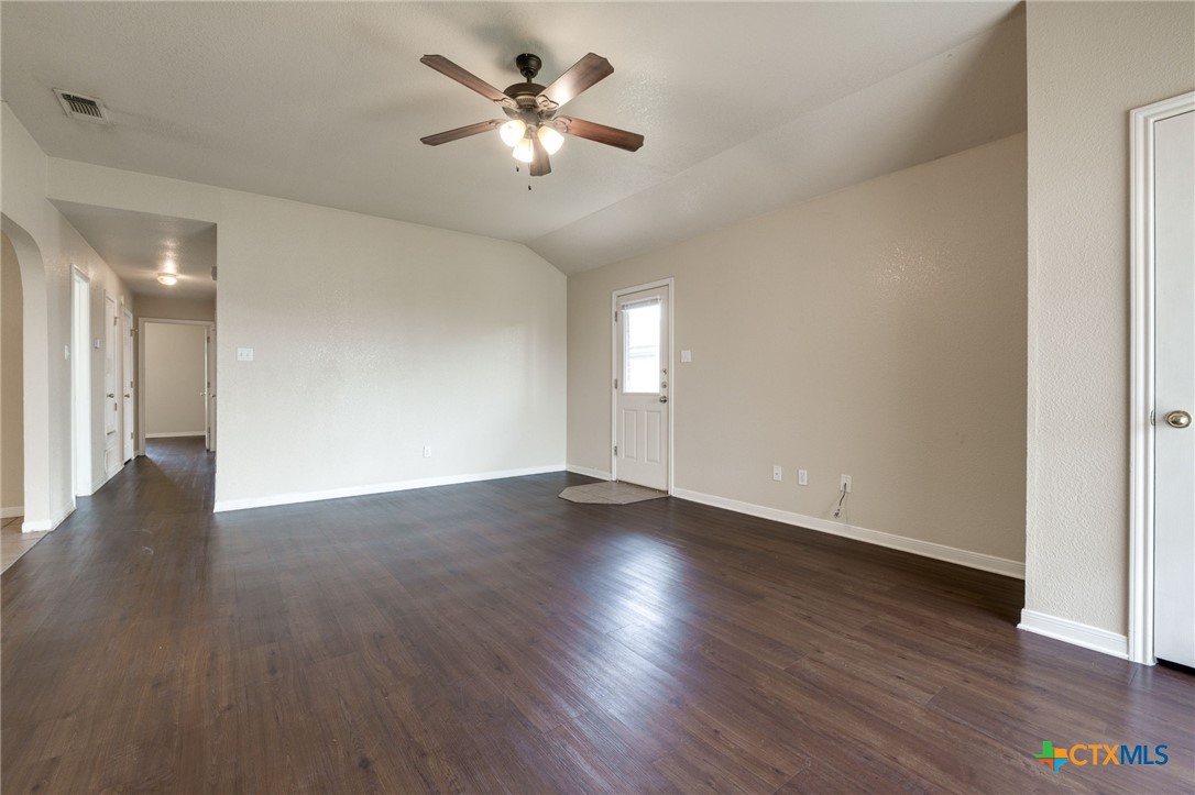 3606 Dustin Court, Unit B Killeen, TX 76549 - Photo 3 of 16 an empty room with wooden floor and ceiling fan
