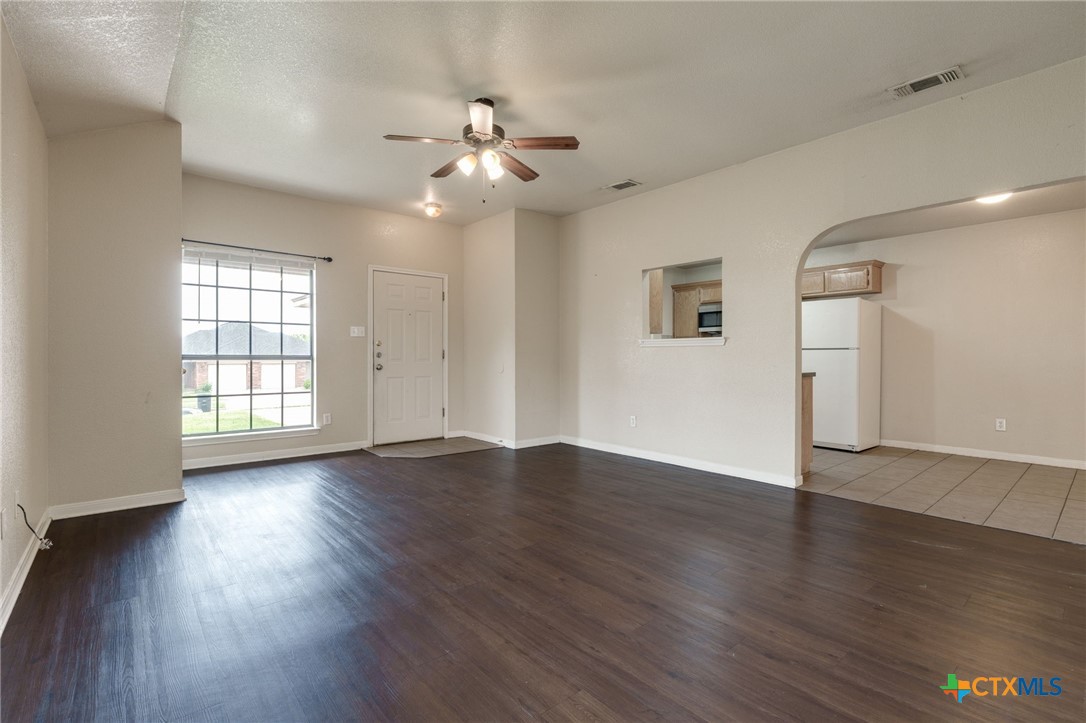 3606 Dustin Court, Unit B Killeen, TX 76549 - Photo 4 of 16 a view of an empty room with wooden floor and a window