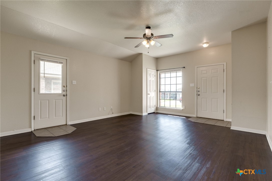 3606 Dustin Court, Unit B Killeen, TX 76549 - Photo 5 of 16 a view of an empty room with wooden floor and a window