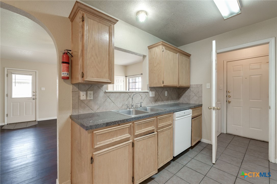 3606 Dustin Court, Unit B Killeen, TX 76549 - Photo 7 of 16 a kitchen with granite countertop a sink and cabinets
