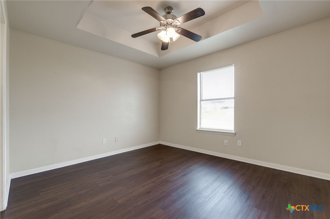 3606 Dustin Court, Unit B Killeen, TX 76549 - Photo 9 of 16 an empty room with wooden floor and windows