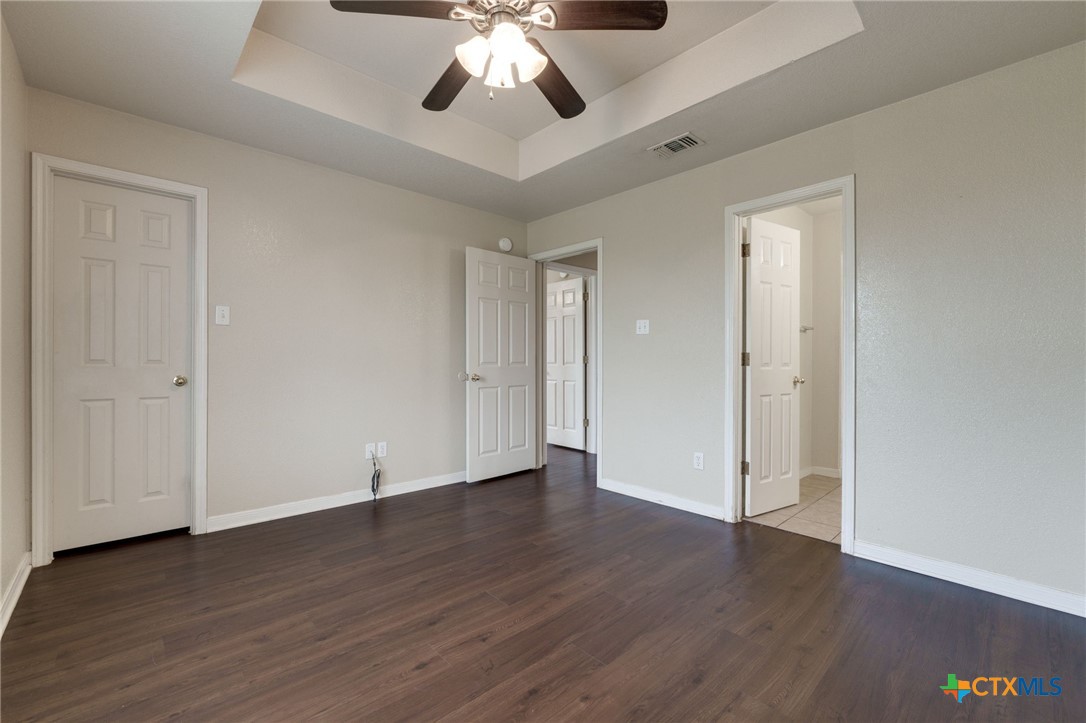 3606 Dustin Court, Unit B Killeen, TX 76549 - Photo 10 of 16 a view of an empty room with wooden floor and a ceiling fan