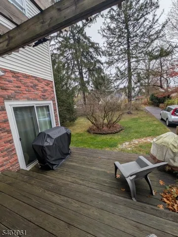 a view of a backyard with table and chairs with wooden floor and fence