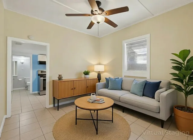 a living room with furniture and a potted plant