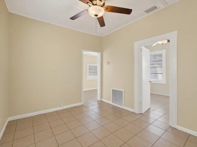 an empty room with closet and windows