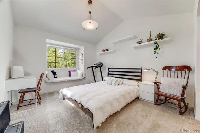 a view of a room with wooden floor and a bed