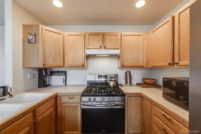 a bathroom with a toilet a sink a mirror and vanity