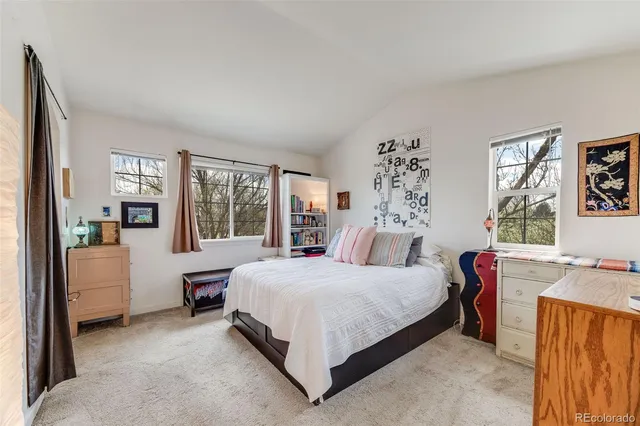 a bathroom with a granite countertop sink a mirror and a bathtub