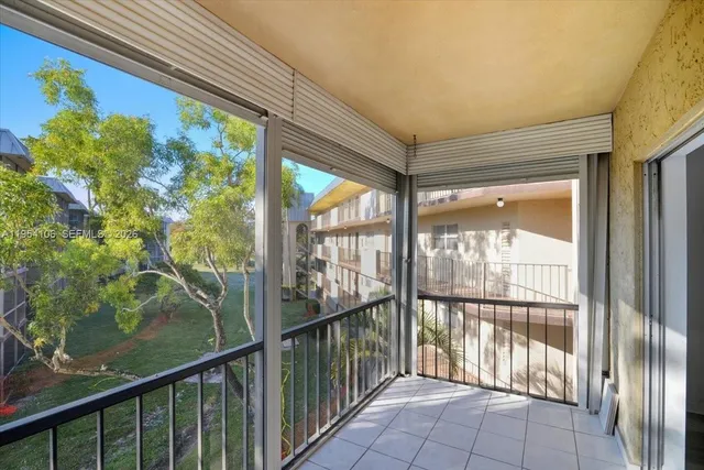 a view of a room with wooden floor and a balcony