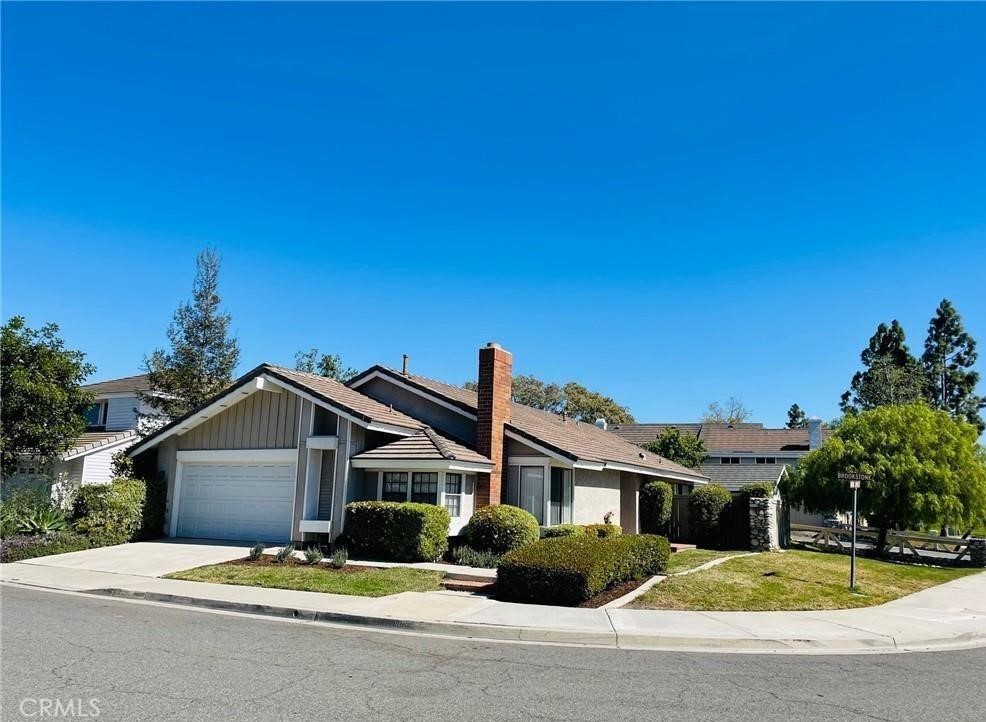 2 Brookstone Avenue Irvine, CA 92604 - Photo 1 of 1 a front view of a house with yard and trees in the background