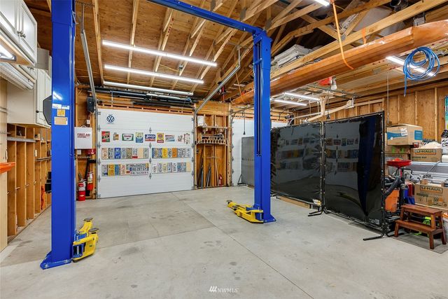 a front view of a house with a yard and potted plants
