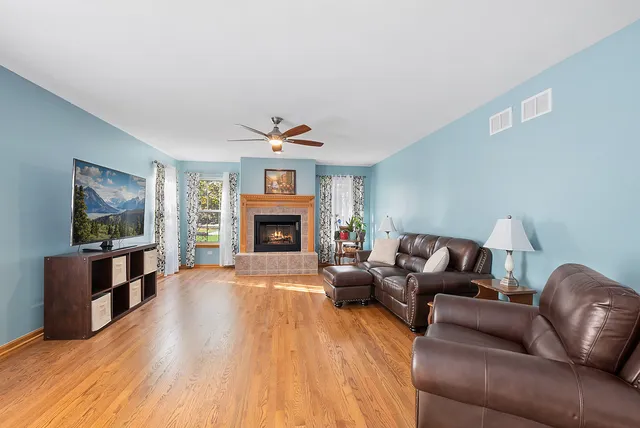 a view of a hallway with furniture and wooden floor