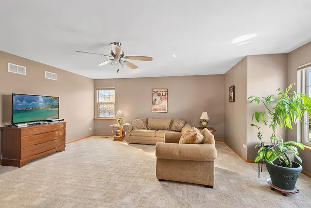 a bedroom with a bed a chandelier and a dresser