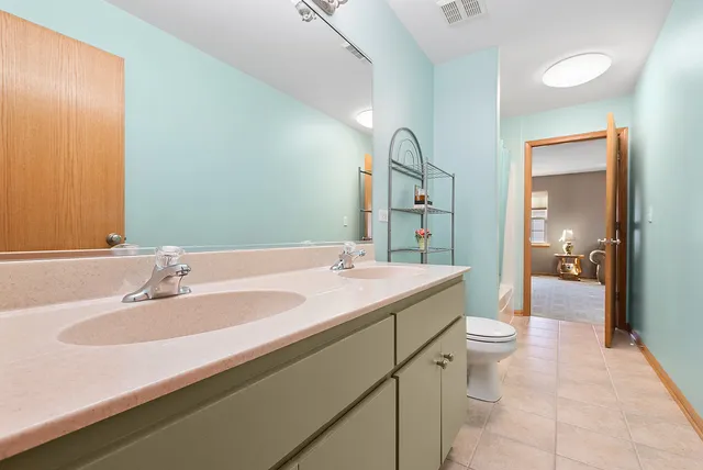 a bathroom with a sink double vanity mirror and a bathtub