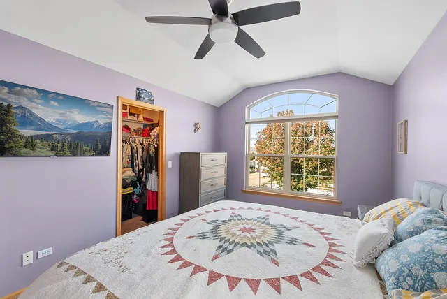 a spacious bedroom with a bed and a sink