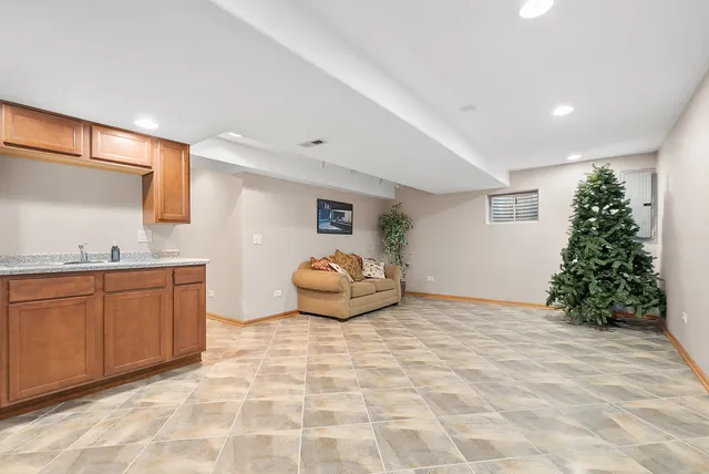 a bedroom with a bed a mirror and lamp