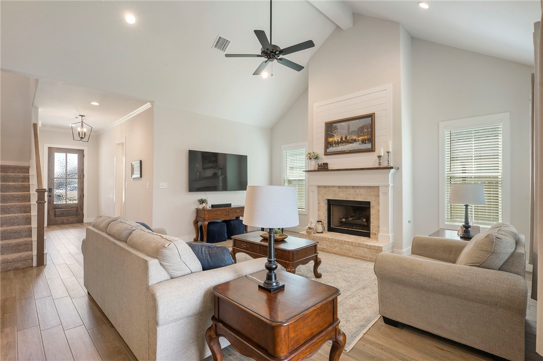 5019 Grayson Way Bryan, TX 77802 - Photo 4 of 26 Living room boasts tasteful color palette and wood look tile for easy maintenance.